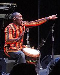 Babacar whoops up the crowd with his djembe
